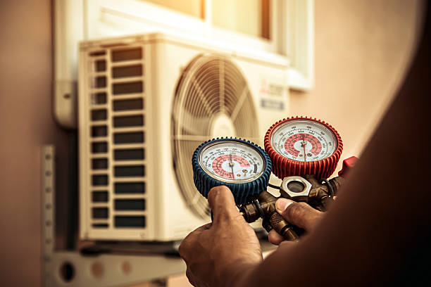 Professional Air Conditioning Service technician working in Oswego, KS